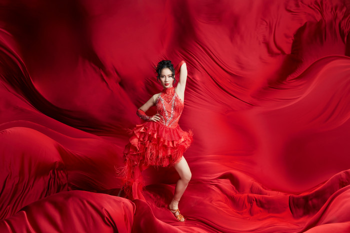 Phạm Lịch tỏa sáng với mẫu váy cổ yếm dáng ngắn màu đỏ rực. Thiết kế này được tạo điểm nhấn bằng chi tiết lông vũ và lớp đính sequin tạo hiệu ứng bắt sáng khi trình diễn trên sân khấu. Về phụ kiện, Phạm Lịch kết hợp thêm bao tay đồng màu.