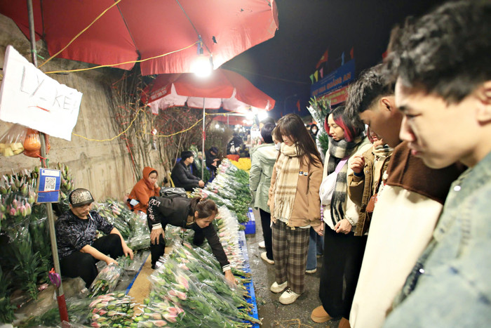 Các bạn trẻ đến chợ hoa Quảng An vừa tham quan vui chơi, vừa tranh thủ mua những bó hoa yêu thích.