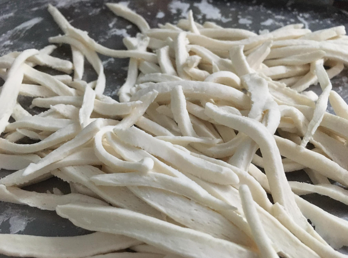 Bột gạo được nhào kỹ, thái thành các vạt mỏng và dài trông giống vạt giường nên món ăn được người địa phương đặt cho cái tên độc đáo như vậy. (Nguồn: Hằng Lê)