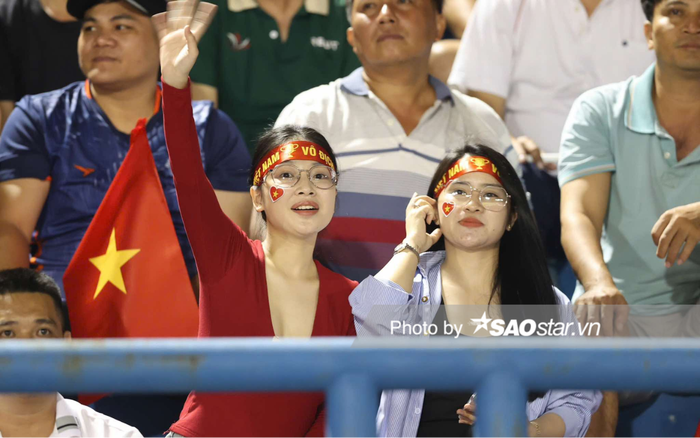 Hai cô gái trẻ ăn diện trẻ trung, thể hiện niềm hâm mộ mãnh liệt dành cho tuyển Việt Nam. Ảnh: Anh Đồng
