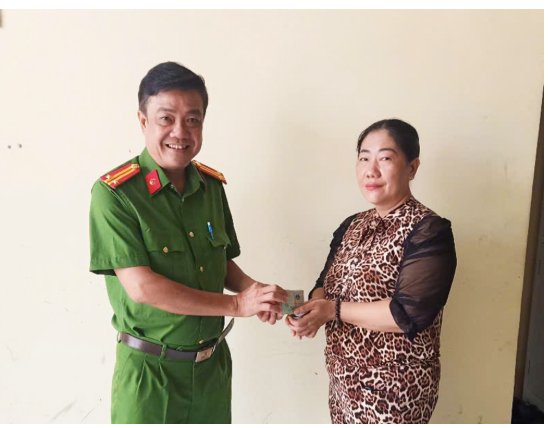 Đại diện Công an xã Nhơn Mỹ trao trả tài sản bị đánh rơi lại cho bà Dung