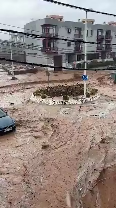 Một chiếc ô tô bị cuốn vào dòng nước trước khi trôi xuống đường và biến mất khỏi tầm nhìn trên đường phố Gran Canaria.