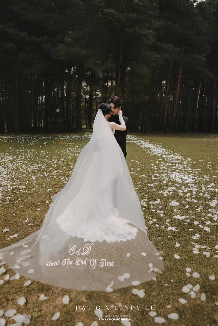 Tà váy dài của cô dâu hơn 2m được thêu dòng chữ “Until the end of time” kèm tên viết tắt của cặp đôi. (Ảnh FBNV)