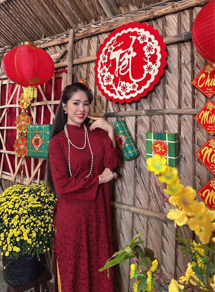 Lê Phương đeo nhiều phụ kiện, thoa son đỏ nổi bật khi mặc áo dài. Ảnh: FBNV