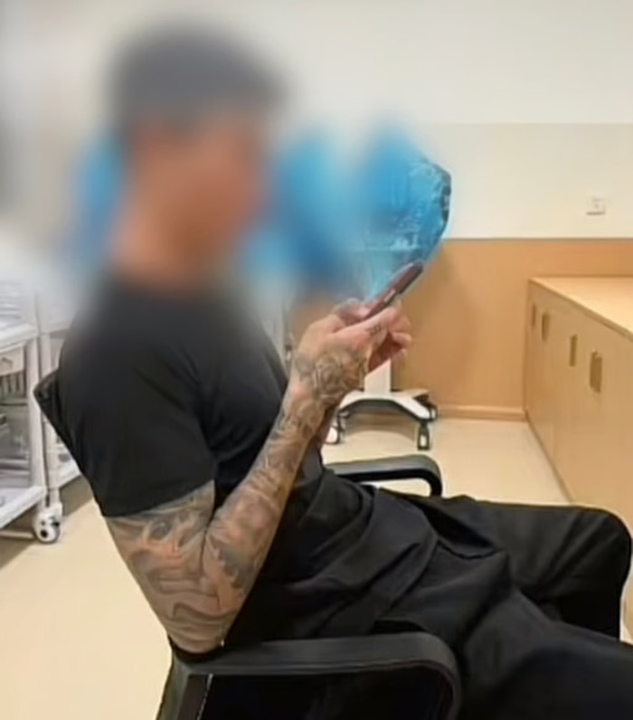 Đoạn video được chia sẻ trên mạng cho thấy bạn trai của người phụ nữ, như hình trên, đang sử dụng điện thoại di động bên trong bệnh viện. Ảnh: gscn.com.cn