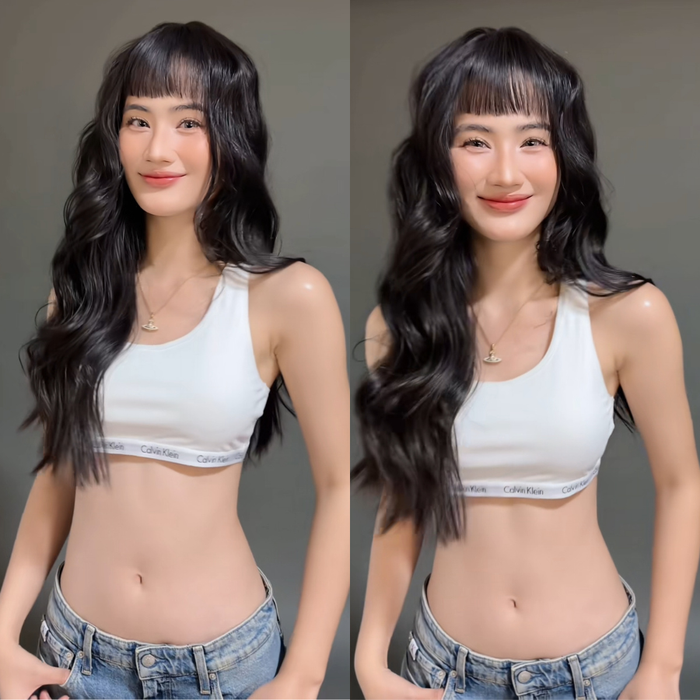 Ý Nhi để mái bằng và uốn tóc xoăn, tự tin tạo dáng khi diện trang phục gợi cảm. Ảnh chụp màn hình