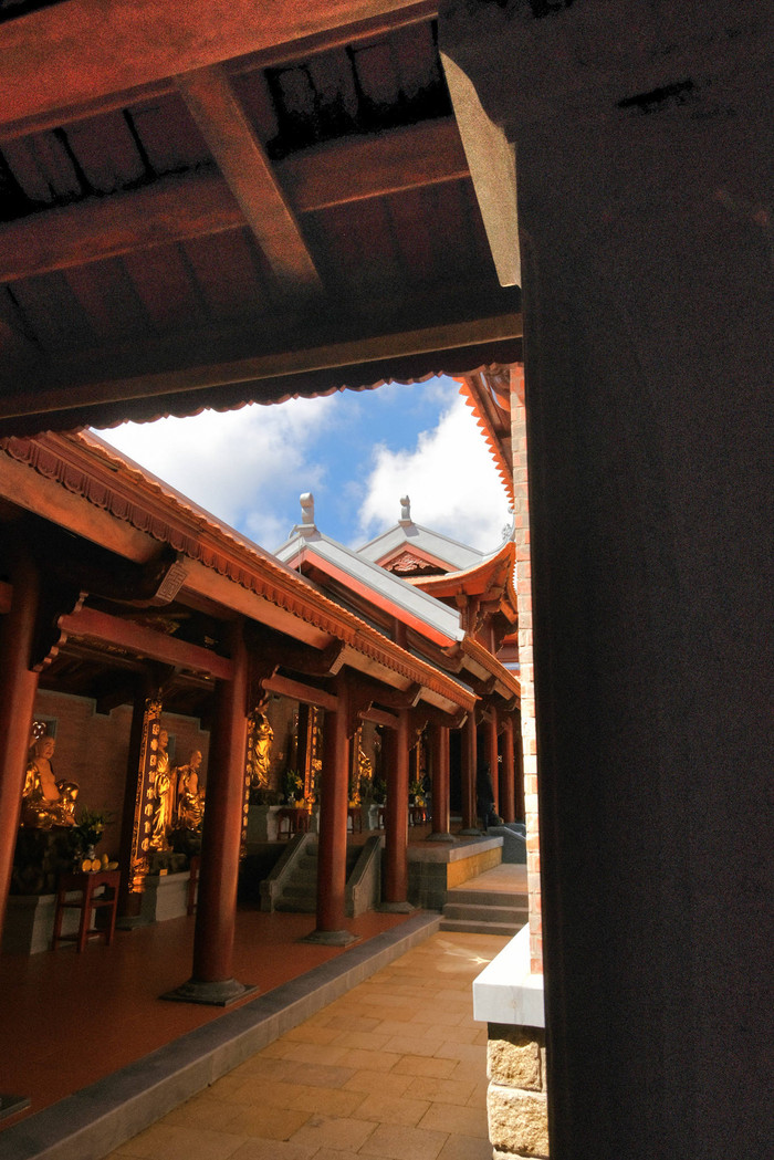 Giữa nền trời xanh, mây trắng và rừng già bạt ngàn, những công trình bằng gỗ hiện lên mộc mạc, trang nghiêm, hòa quyện với thiên nhiên, tạo nên tổng thể hài hòa và thanh tịnh. Ảnh: Phạm Trường