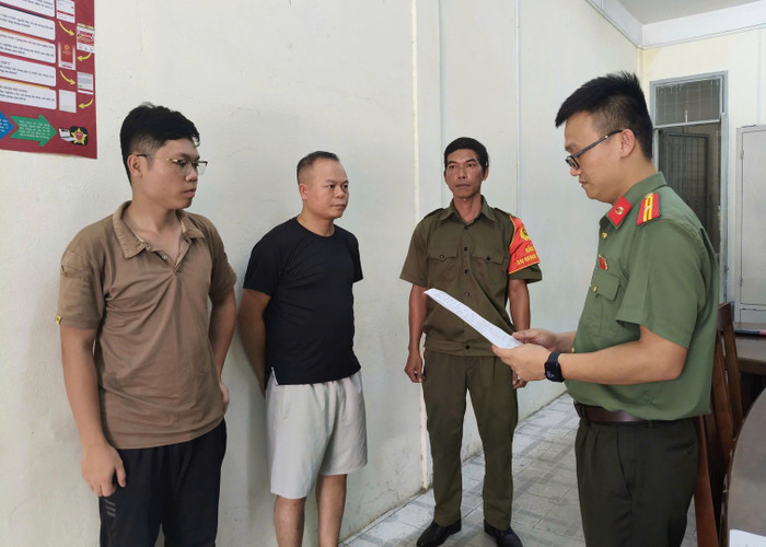 Cơ quan An ninh điều tra Công an TP Đà Nẵng tống đạt các quyết định đối với Chu Đức Anh (áo đen) và Nguyễn Trung Hiếu (ngoài cùng bên trái).&nbsp;