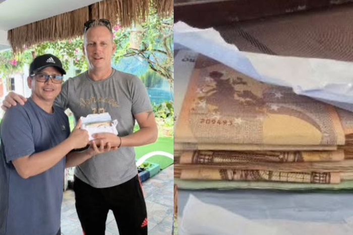 Guy Petcharat, chủ một cơ sở lưu trú gần sân bay Phuket (bên trái), trao lại một xấp tiền euro trị giá khoảng 100.000 baht cho một du khách người Pháp. Ảnh: Guy Petcharat