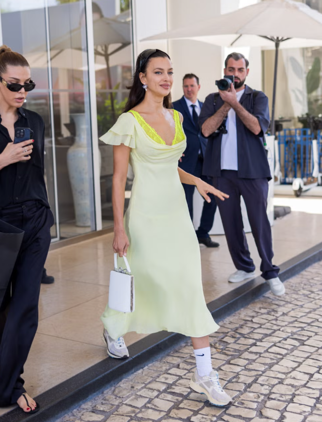 Một chiếc váy lụa midi viền ren phối cùng sneakers tưởng chừng đơn giản nhưng lại tạo nên outfit cực chất theo phong cách Irina Shayk. Kết hợp với tất slouchy, Nike cổ điển và kính aviator chunky, set đồ trở nên deliberately offbeat, vừa thoải mái, vừa phong cách, chuẩn fashionista mùa xuân. Ảnh: Getty Images