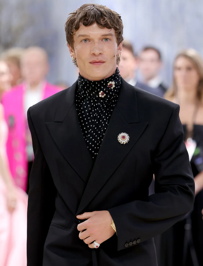 Connor Storrie gây ấn tượng khi xuất hiện trong bộ suit Saint Laurent may đo, kết hợp đồng hồ Omega và trâm cài Tiffany & Co. đính bạc và ruby, tạo điểm nhấn tinh tế cho diện mạo lịch lãm. Ảnh: Getty