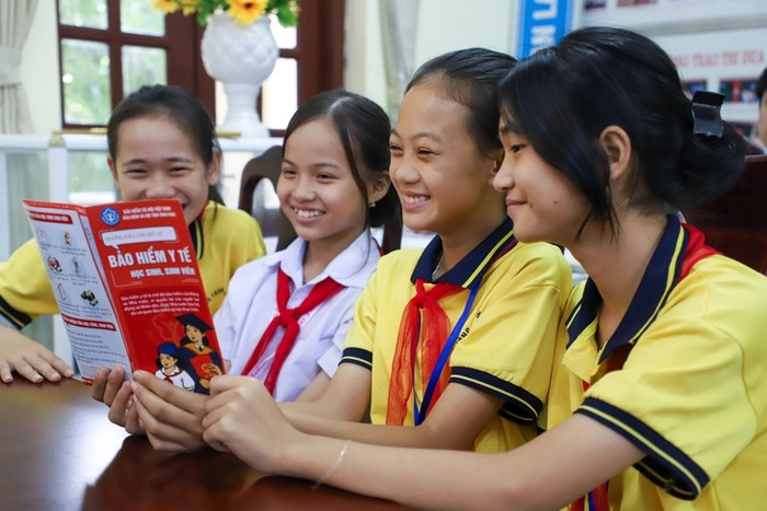 Học sinh xem thông tin quyền lợi bảo hiểm y tế - Ảnh: HÀ QUÂN&nbsp;
