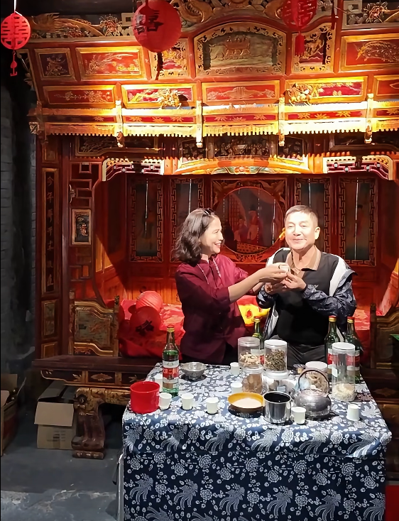 NSƯT Chí Trung diễn cảnh 'giao bôi' cùng bạn gái Ý Lan.