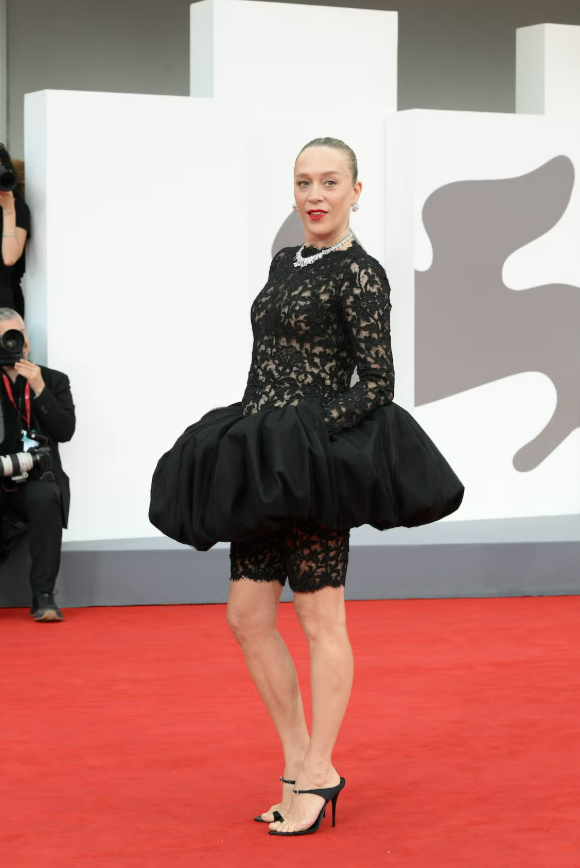 Chloë Sevigny ghi dấu với khả năng đưa thời trang cao cấp đến gần hơn với công chúng mà vẫn giữ được cá tính riêng. Năm 2025, cô diện catsuit ren bên dưới chân váy peplum của Saint Laurent, kết hợp giày cao gót kiểu dáng phá cách và trang sức bản lớn. Sự pha trộn giữa nét nữ tính và tinh thần nghịch ngợm tạo nên diện mạo đặc trưng của nữ diễn viên. Ảnh: Getty Images