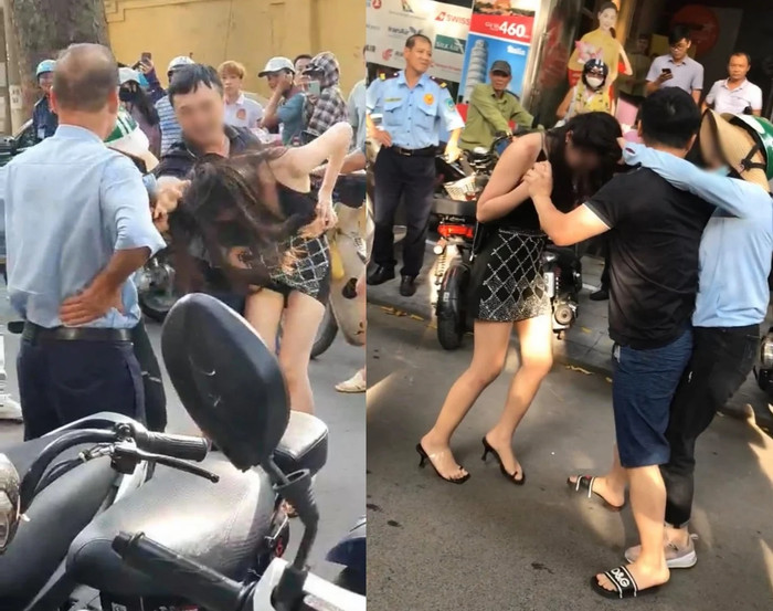 Người vợ (đội mũ bảo hiểm) bắt quả tang chồng và 'nhân tình' trên phố. Ảnh cắt từ clip