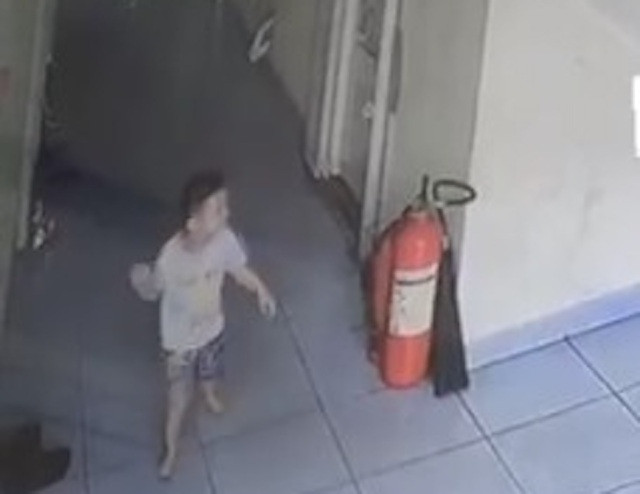 Bé trai 20 tháng tuổi chơi đùa ở hành lang tầng 3 chung cư. Ảnh: Dân Trí