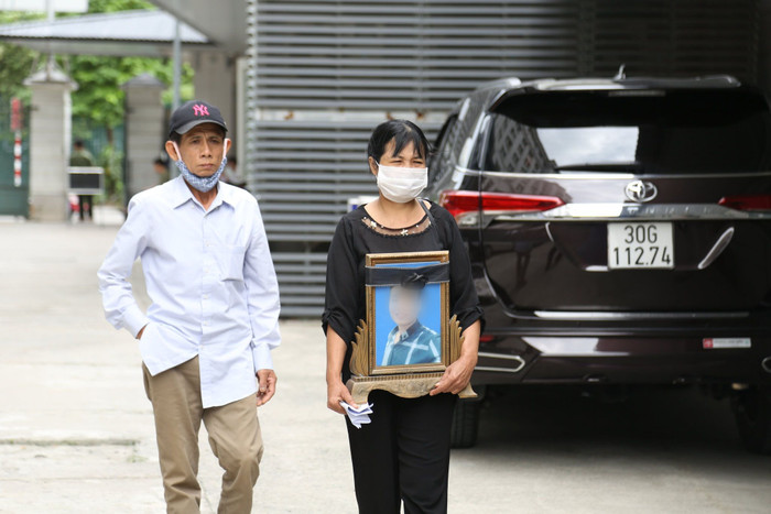 Mẹ nạn nhân ôm di ảnh con trai tới toà.
