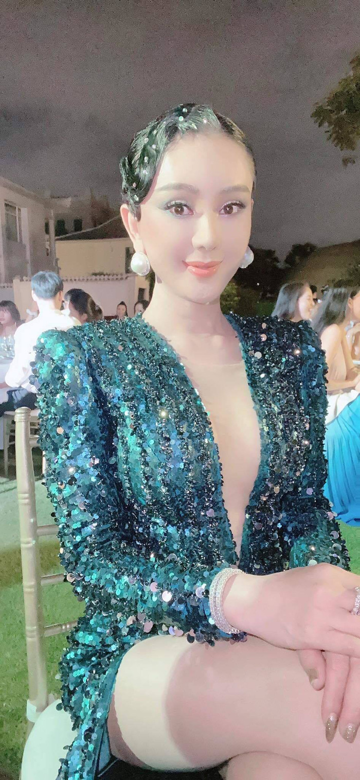 Chiếc váy xẻ sâu khoe khéo thềm ngực quyến rũ, đi cùng kiểu tóc đính hạt đồng điệu. 