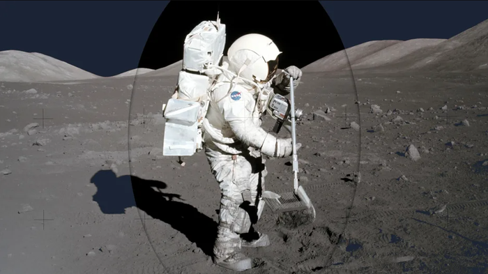 Một nhà khoa học NASA lấy mẫu đá từ Mặt trăng. Ảnh: NASA