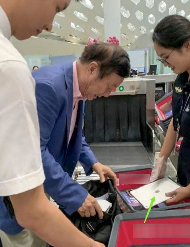 CEO Nhậm Chính Phi mang theo một chiếc iPad khi đi qua cửa kiểm tra an ninh tại một sân bay. (Ảnh: Weibo)