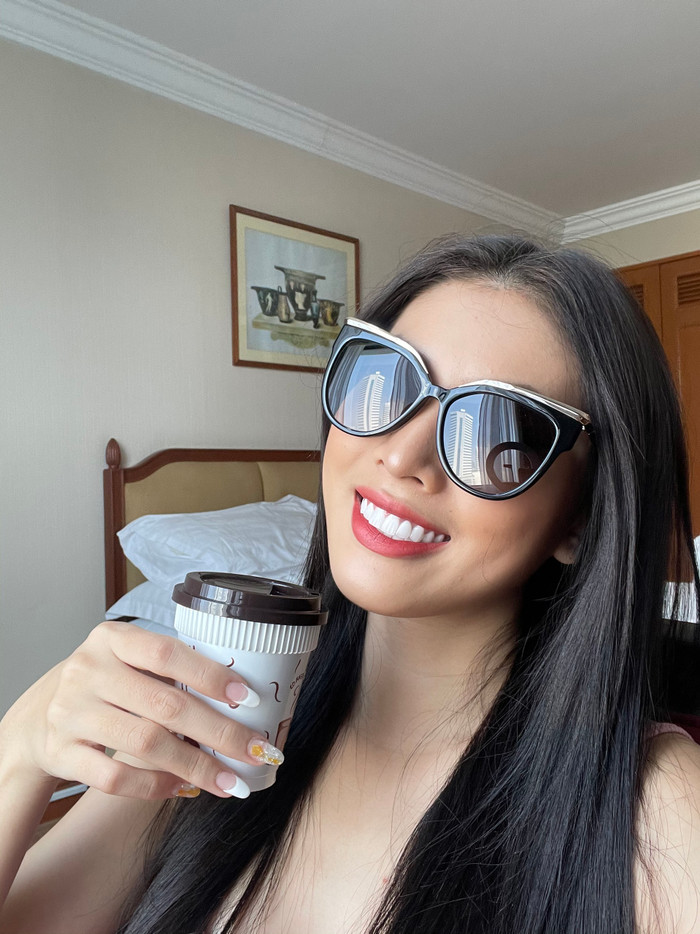 Chào ngày mới với kính mắt đen cùng ly cafe trên tay 