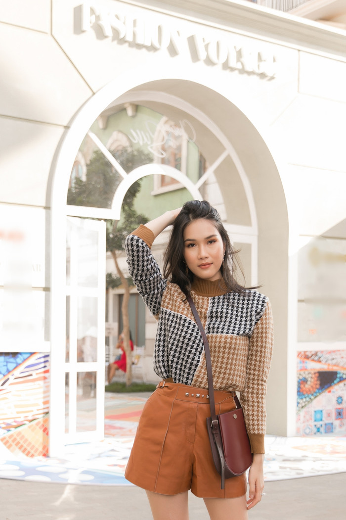 Á hậu Phương Anh vô cùng kín đáo với áo cổ cao cùng quần short và boots mang tông màu của đất. 