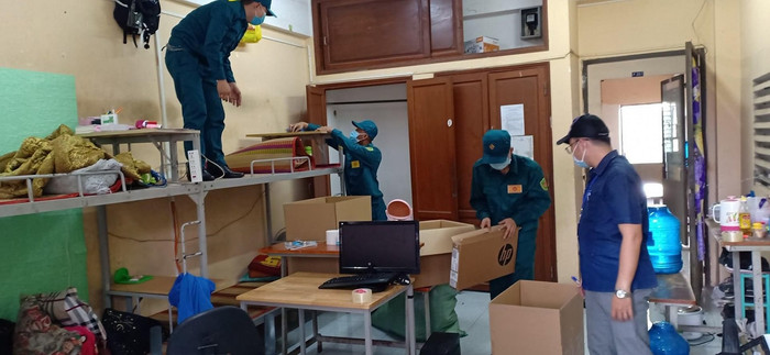 Đội dân quân tự vệ giúp sinh viên dọn dẹp, niêm phong đồ đạc tại phòng KTX trước khi chuyển thành nơi cách ly tập trung