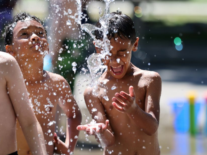 Nhưng đứa trẻ vui đùa dưới nước trong một công viên ở Seattle. Ảnh: Reuters
