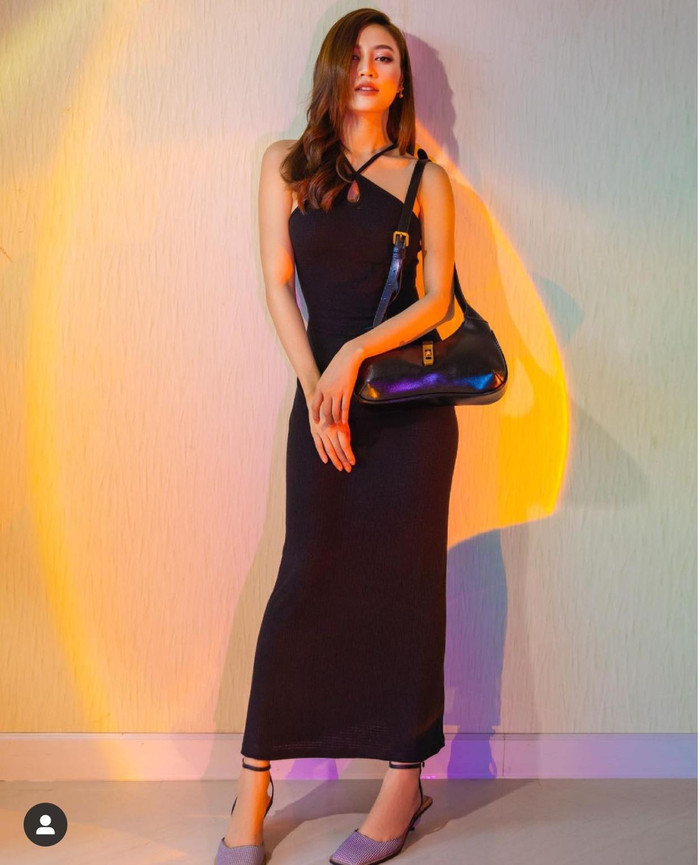 Ninh Dương Lan Ngọc mặc váy đen dài ôm sát body mix cùng túi xách đen vintage và giày gót quấn dây
