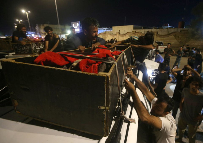 Người thân khóc nghẹn bên thi thể nạn nhân sau vụ cháy bệnh viện. Ảnh: Reuters