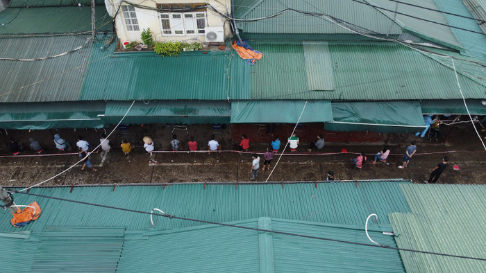 Hàng chục tiểu thương đã đến chợ từ sớm để chờ lấy mẫu. 