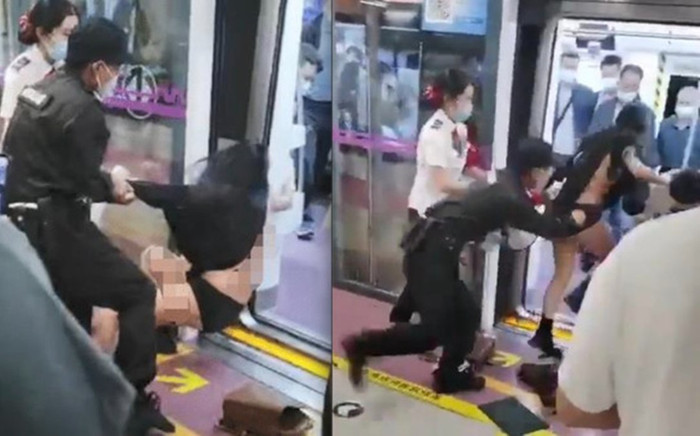 Cãi nhau trên tàu điện ngầm, cô gái bị nhân viên an ninh lôi tuột váy Ảnh 2