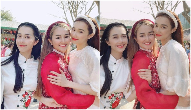 Các chị em cùng nhau khoe sắc với áo dài mang hai tông đỏ, trắng. 