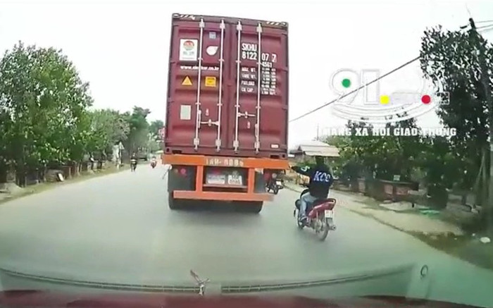 Clip: Ngán ngẩm thanh niên đầu trần, chạy xe máy liều lĩnh đu bám vào đuôi container trên đường Ảnh 2