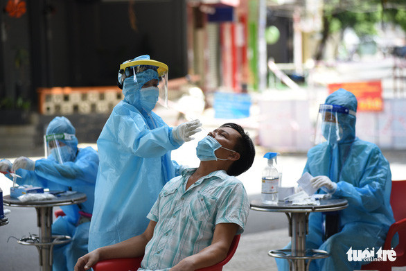 Nhân viên y tế lấy mẫu cho người dân phường 3, quận Bình Thạnh - Ảnh: DUYÊN PHAN