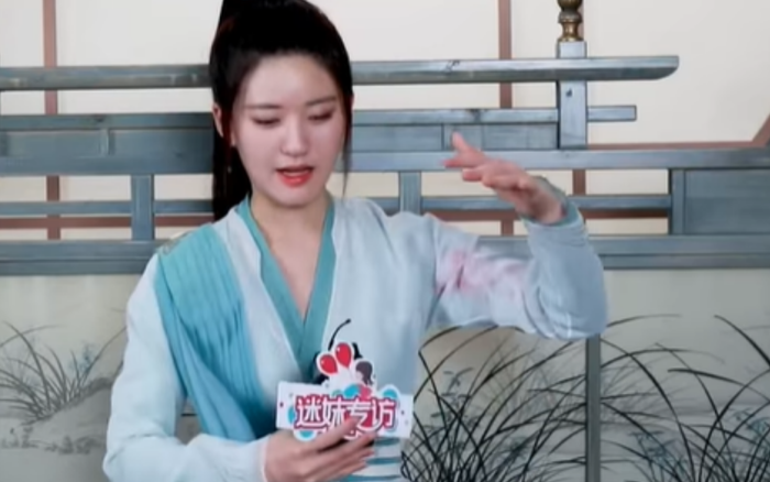 Triệu Lộ Tư đang mô tả chiếc quạt của mình.