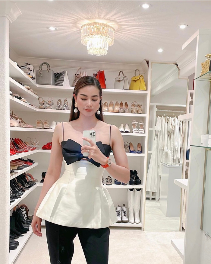 Nàng hậu chụp ảnh trước gương nhưng tủ đồ hiệu phía sau mới là điểm gây chú ý với khán giả.