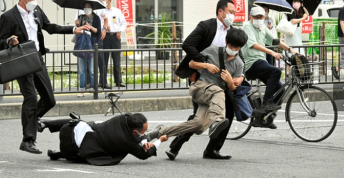 Nghi phạm mặc áo xám bỏ trốn sau khi bắn 2 phát súng.