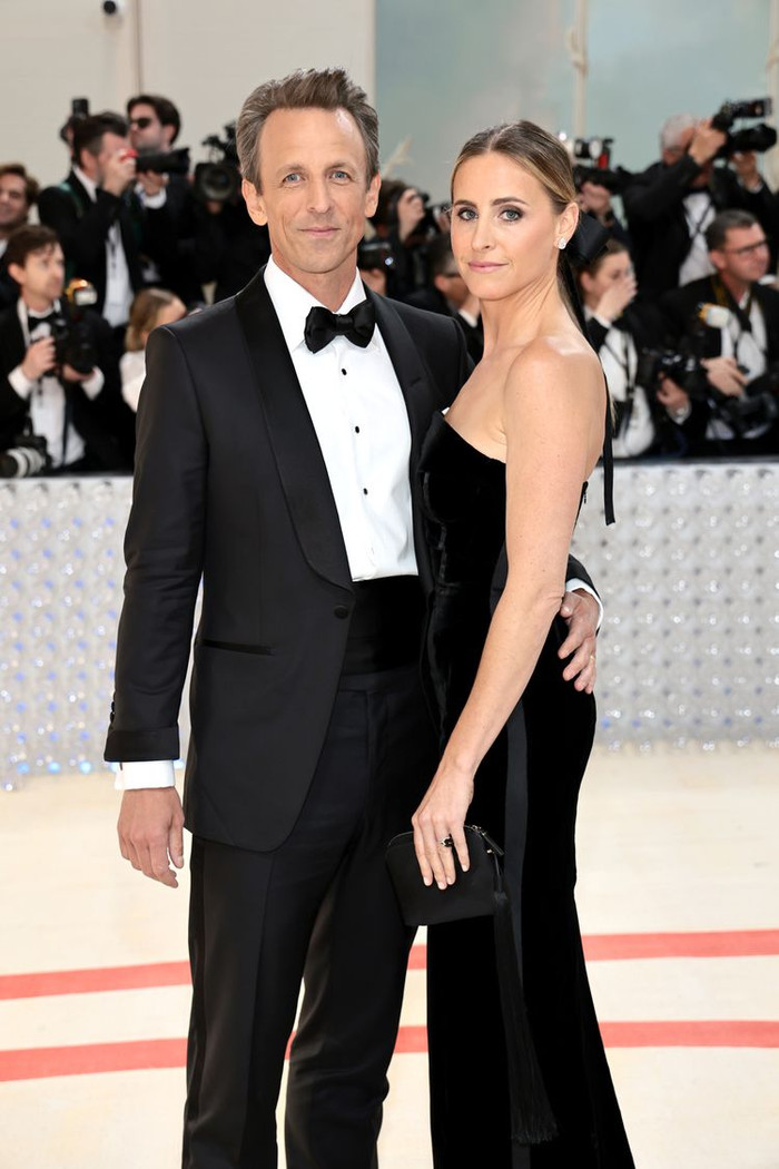 Ashe mặc một chiếc váy cột đen bóng mượt trong khi Meyers chọn một bộ tuxedo đen cổ điển.